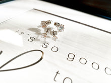 Load image into Gallery viewer, Two sets of zirconia earrings on top of sign that says "it's so good"